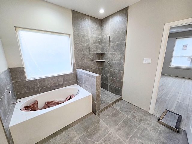 bathroom with shower with separate bathtub