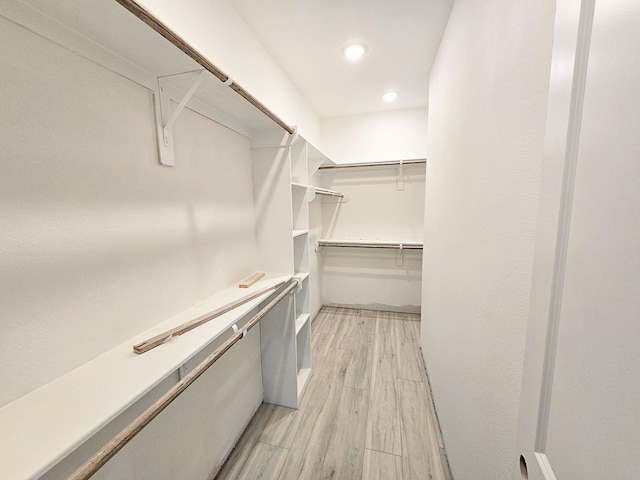 spacious closet featuring light hardwood / wood-style flooring