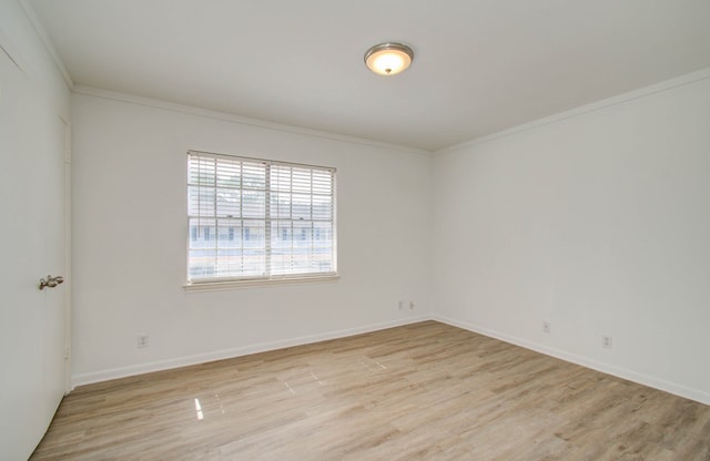 empty room with crown molding and light wood-type flooring