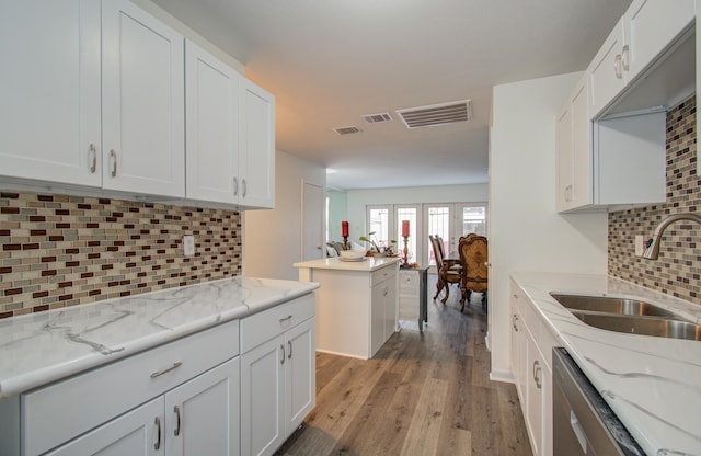 kitchen featuring sink, white cabinets, and light wood-type flooring