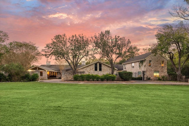 view of front of property with a chimney and a front lawn