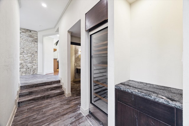 hallway with baseboards and wood finished floors