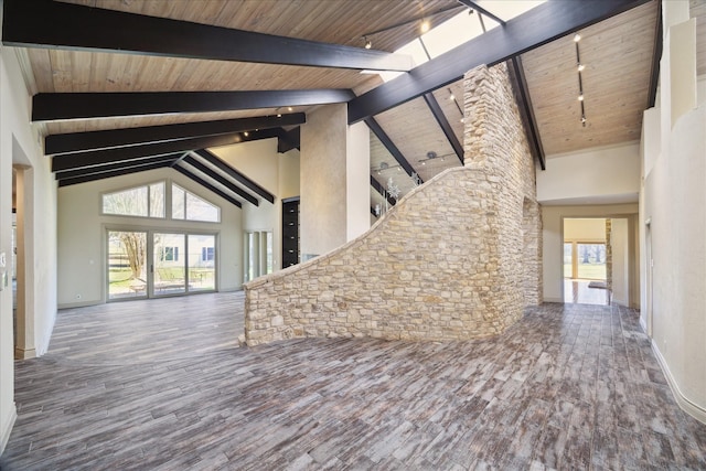 unfurnished living room featuring high vaulted ceiling, beamed ceiling, and wood finished floors