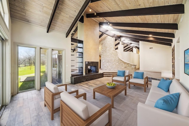 sunroom / solarium featuring a glass covered fireplace, wood ceiling, and lofted ceiling with beams