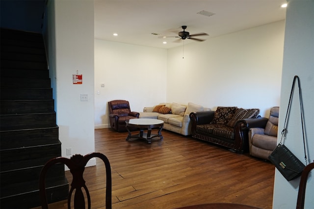 living room featuring ceiling fan and dark hardwood / wood-style flooring