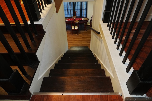 staircase with wood-type flooring