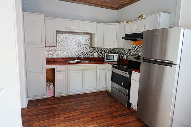 kitchen featuring backsplash, dark wood-type flooring, white cabinets, sink, and appliances with stainless steel finishes