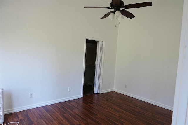 unfurnished room featuring ceiling fan and dark wood-type flooring