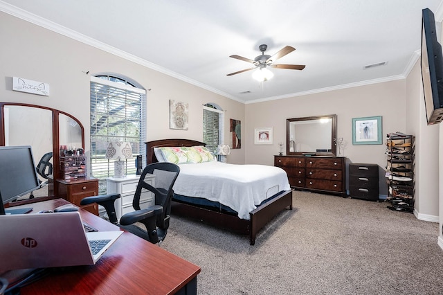 carpeted bedroom featuring ceiling fan and crown molding