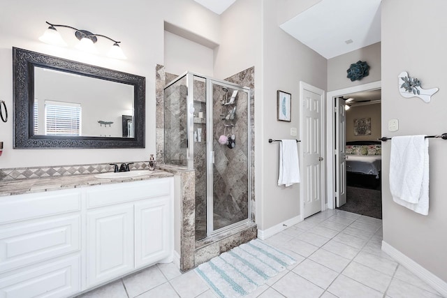 bathroom with tile patterned flooring, vanity, ceiling fan, and an enclosed shower