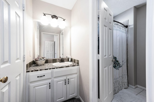 bathroom with tile patterned flooring, a textured ceiling, vanity, and a shower with shower curtain