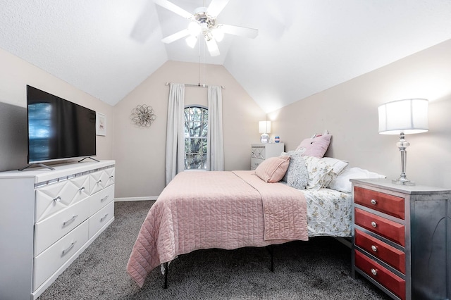 bedroom featuring dark colored carpet, vaulted ceiling, and ceiling fan