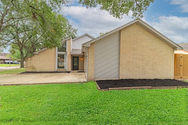 back of property featuring a lawn