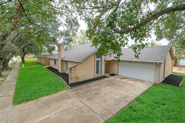 ranch-style home featuring a garage and a front lawn