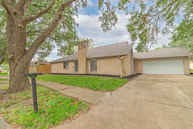 single story home featuring a front lawn and a garage