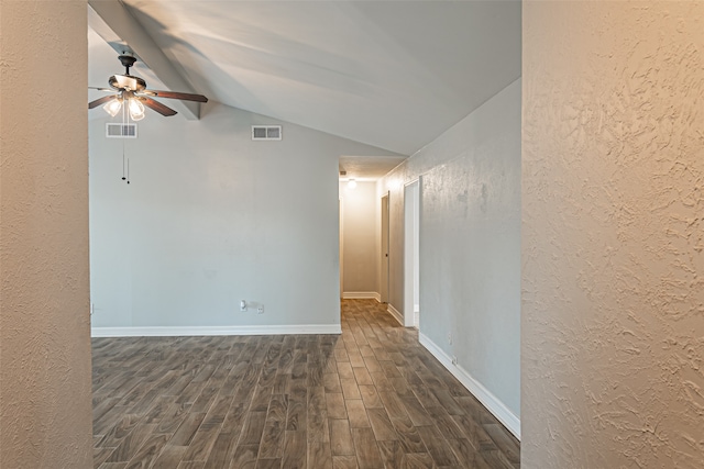 spare room featuring dark hardwood / wood-style floors, ceiling fan, and lofted ceiling