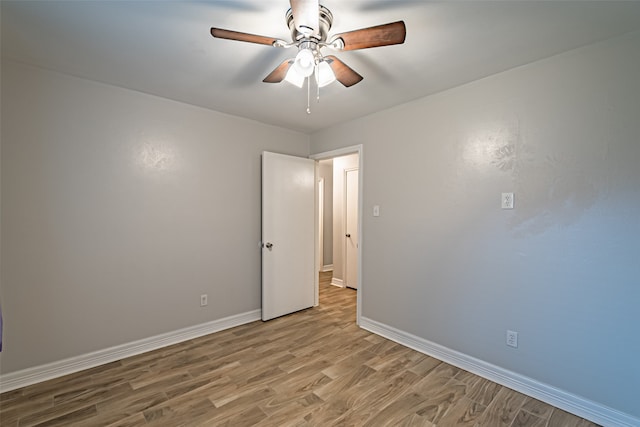 spare room featuring light hardwood / wood-style flooring and ceiling fan