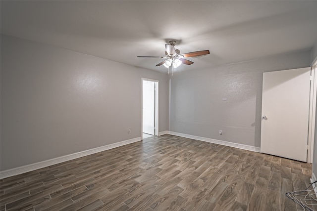 unfurnished room with ceiling fan and dark wood-type flooring