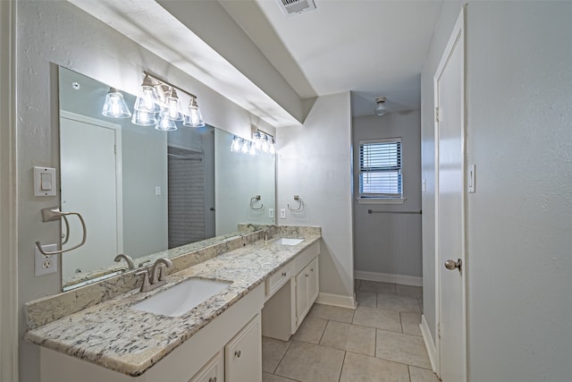 bathroom with tile patterned flooring and vanity