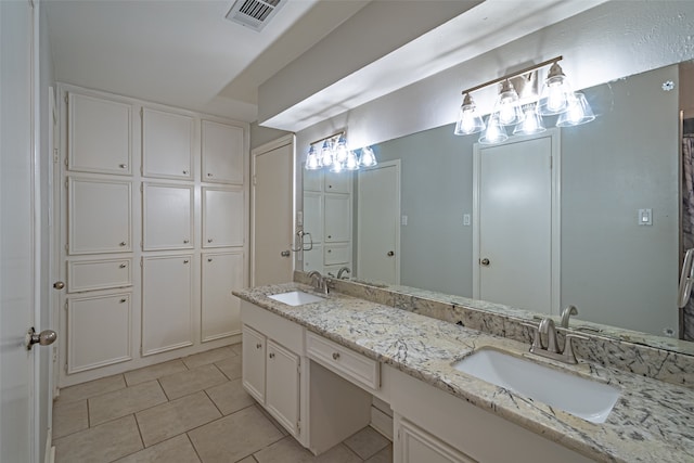 bathroom with tile patterned flooring and vanity