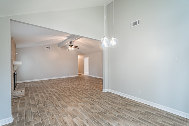 unfurnished living room featuring a brick fireplace, light wood-type flooring, vaulted ceiling, and ceiling fan