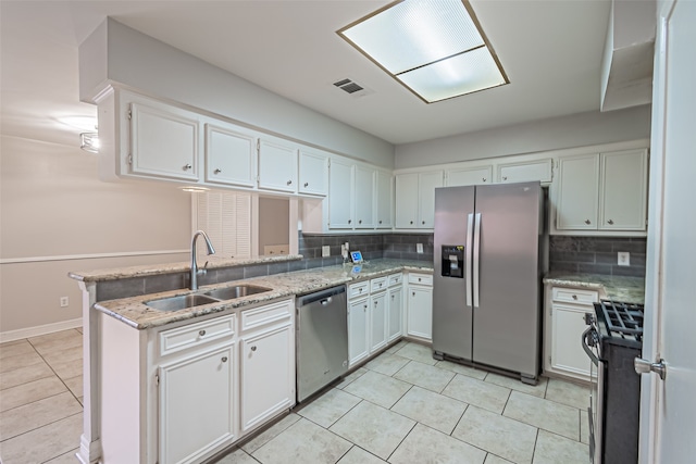 kitchen featuring kitchen peninsula, backsplash, stainless steel appliances, sink, and white cabinetry