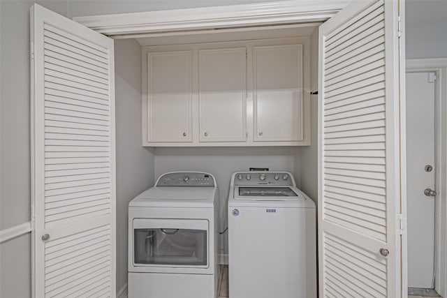 washroom featuring cabinets and washer and dryer