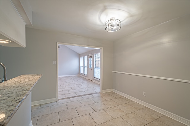 unfurnished dining area with light tile patterned flooring