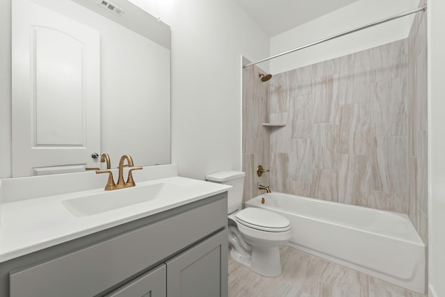 full bathroom with vanity, toilet, and tiled shower / bath