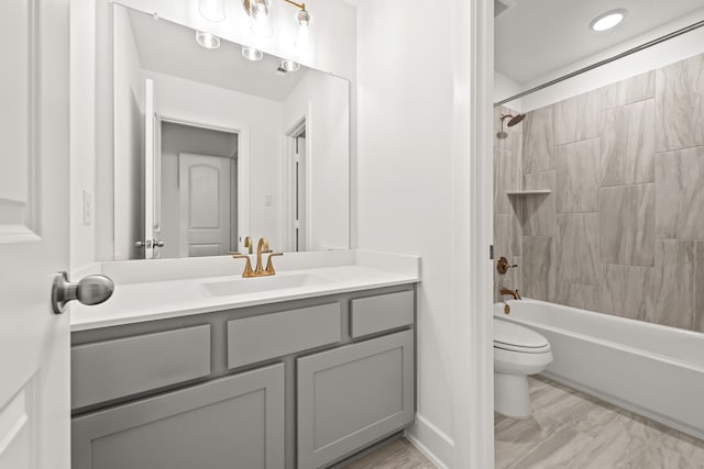 full bathroom with vanity, toilet, and tiled shower / bath