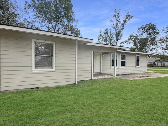 rear view of house with a lawn