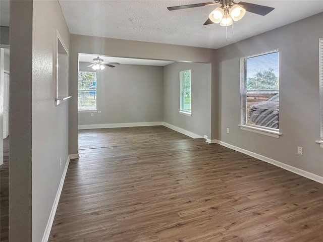 spare room featuring ceiling fan, dark hardwood / wood-style flooring, and a textured ceiling