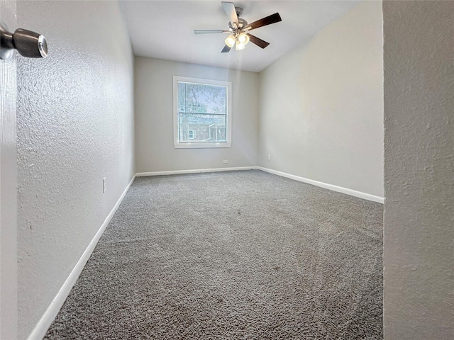 empty room featuring carpet floors and ceiling fan