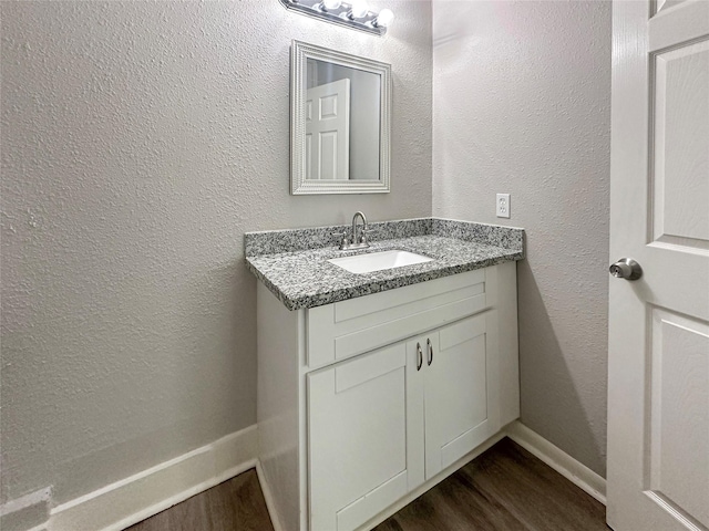 bathroom featuring vanity and hardwood / wood-style flooring