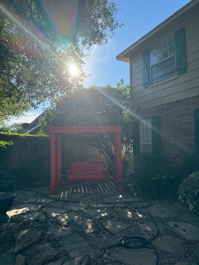 view of gate featuring a patio area