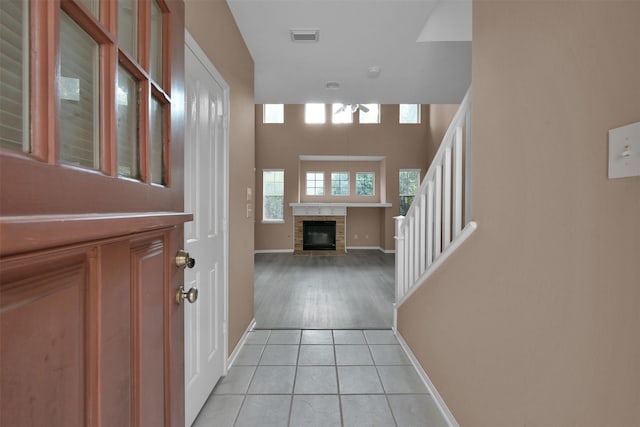 tiled foyer entrance featuring a fireplace