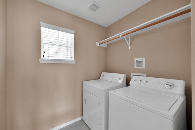 laundry room with light tile patterned flooring and washer and dryer