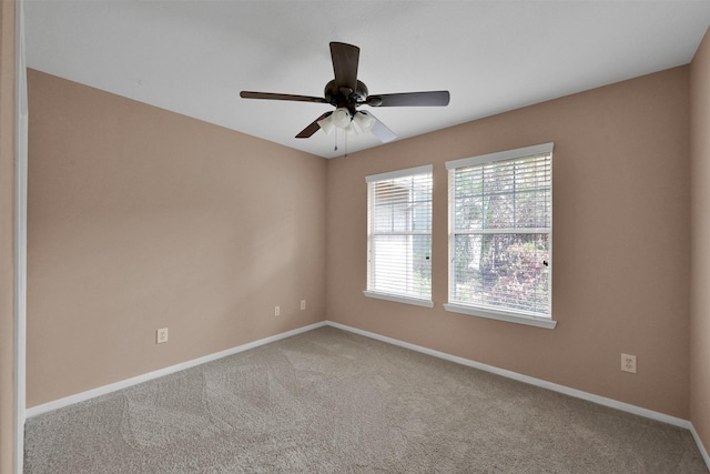 unfurnished room with carpet flooring and ceiling fan