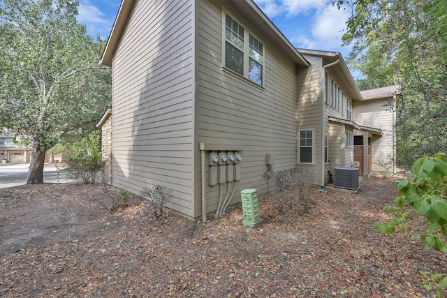 view of side of property featuring central AC