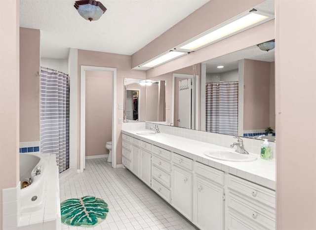 full bathroom featuring tile patterned flooring, vanity, toilet, and a textured ceiling