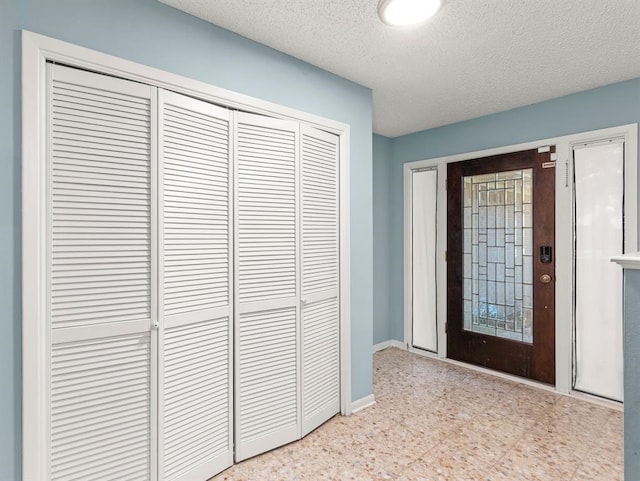 entryway with a textured ceiling