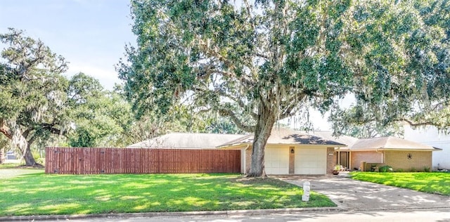 view of front facade with a front yard and a garage