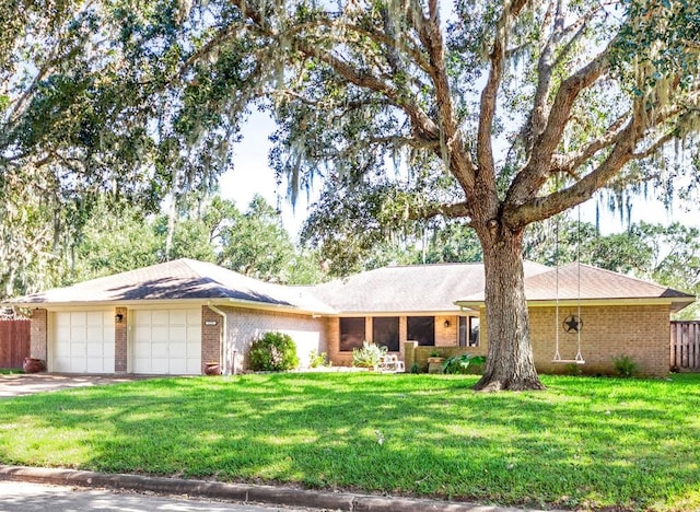 ranch-style house featuring a garage and a front lawn