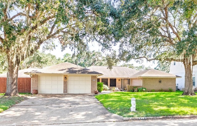 ranch-style home featuring a front yard and a garage