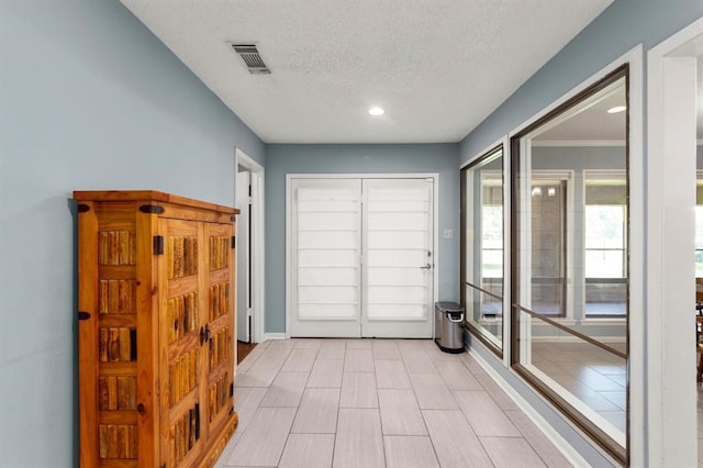 doorway featuring a textured ceiling