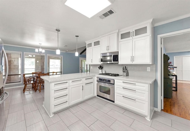 kitchen with stainless steel appliances, kitchen peninsula, light hardwood / wood-style floors, decorative light fixtures, and white cabinets