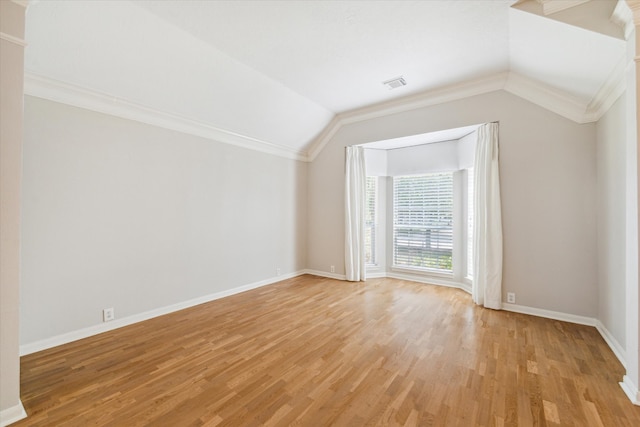 additional living space featuring light hardwood / wood-style floors and vaulted ceiling