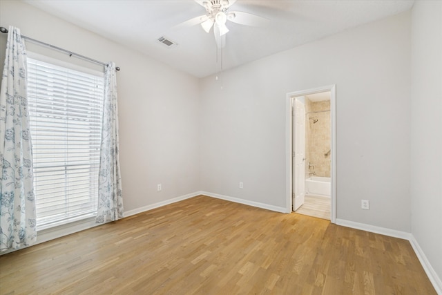 empty room with ceiling fan and light hardwood / wood-style floors