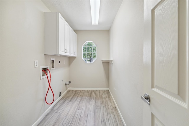 clothes washing area featuring cabinets, hookup for an electric dryer, gas dryer hookup, hookup for a washing machine, and light wood-type flooring