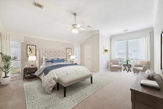 carpeted bedroom with multiple windows, vaulted ceiling, ceiling fan, and ornamental molding